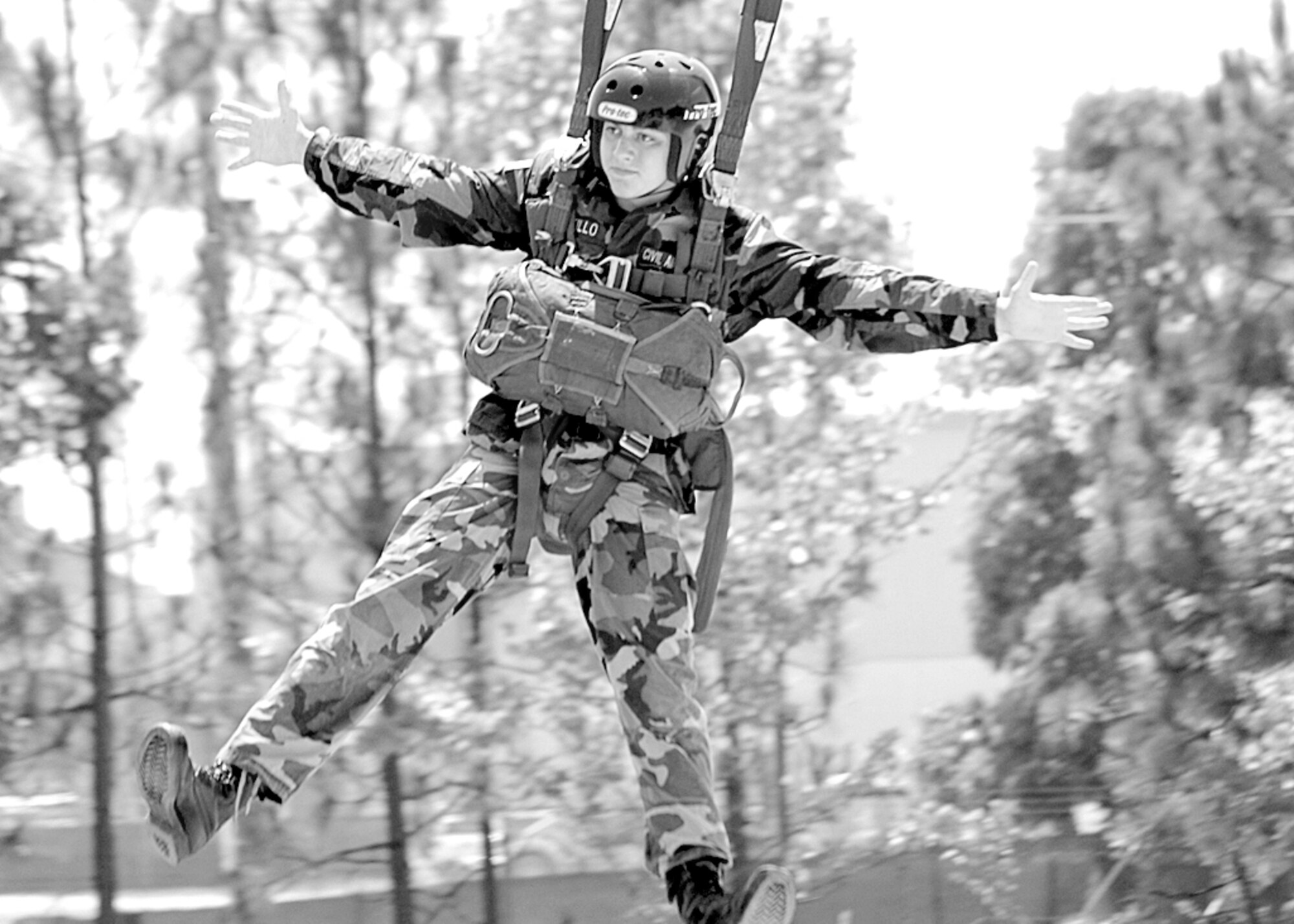 Chris Pitillo, Civil Air Patrol cadet, performs a zip lining maneuver off a 34 ft. tower at a Fort Bragg training course July 21. (U.S. Photo by Airnan 1st Class Mindy Bloem)