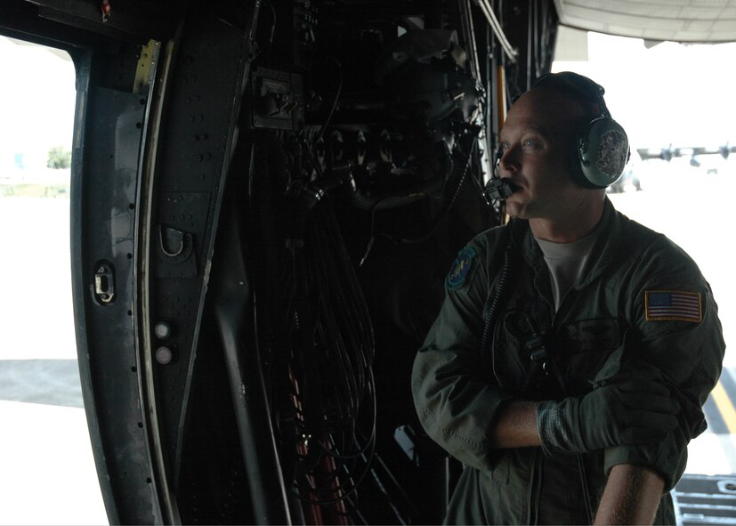 Staff Sgt. Shawn Cooper, 711th Special Operations Squadron loadmaster, watches the engines fire up before closing the doors before an MC-130 sortie July 30.  The 919th launched more than 850 sorties and averaged more than 2,000 flight hours last year.  (U.S. Air Force photo/Staff Sgt. Jon McCallum.)