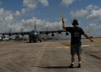 Mike Zukusky, 919th Aircraft Maintenance Squadron crew chief, directs the pilot to turn the MC-130 as it taxis to the runway for a mission July 30 at Duke Field. The 919th launched more than 850 sorties and averaged more than 2,000 flight hours last year.  (U.S. Air Force photo/Staff Sgt. Samuel King Jr.)