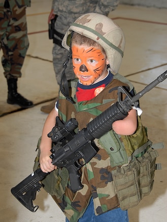 Jared Thompson poses with a tiger-face painting in field gear at the Family Day event held on August 1 at the Utah Air Naitonal Guard Base, Utah.  The Family Day celebration included live music, food, fun kids activities, air craft static displays, KC-135 fly-bys, and numerous military exhibits. U.S. Air Force photo by Staff Sgt. Emily Monson.
