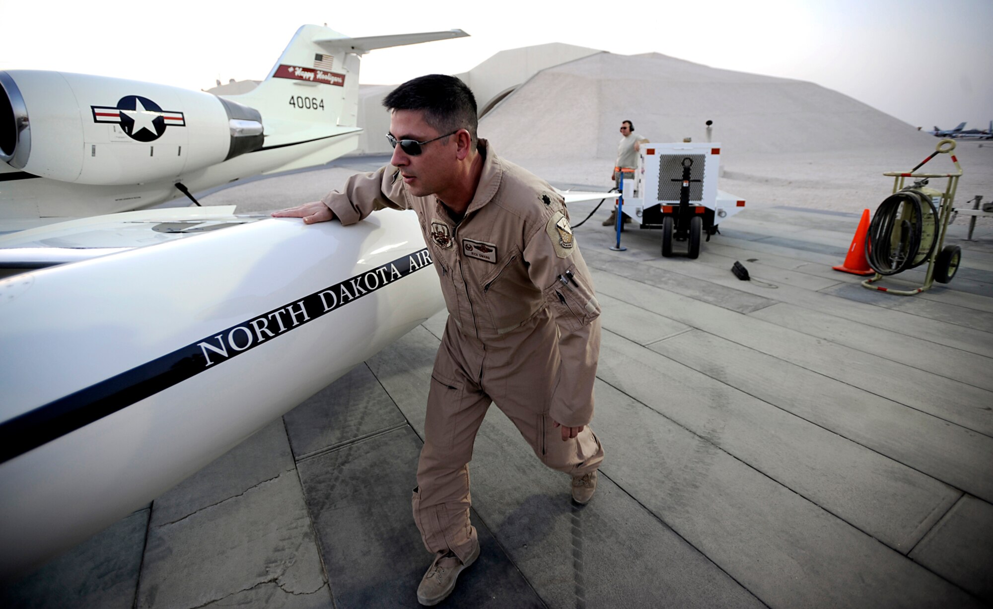 Lt. Col. Rick Omang, a C-21 pilot assigned to the 379th Expeditionary Operations Group, conducts a pre-flight inspection prior to conducting combat operations over Southwest Asia July 26. The C-21 is a twin turbofan engine aircraft used for cargo and passenger airlift. Colonel Omang is deployed from the 177th Airlift Squadron, North Dakota Air National Guard. (U.S. Air Force photo by Staff Sgt. Shawn Weismiller)
