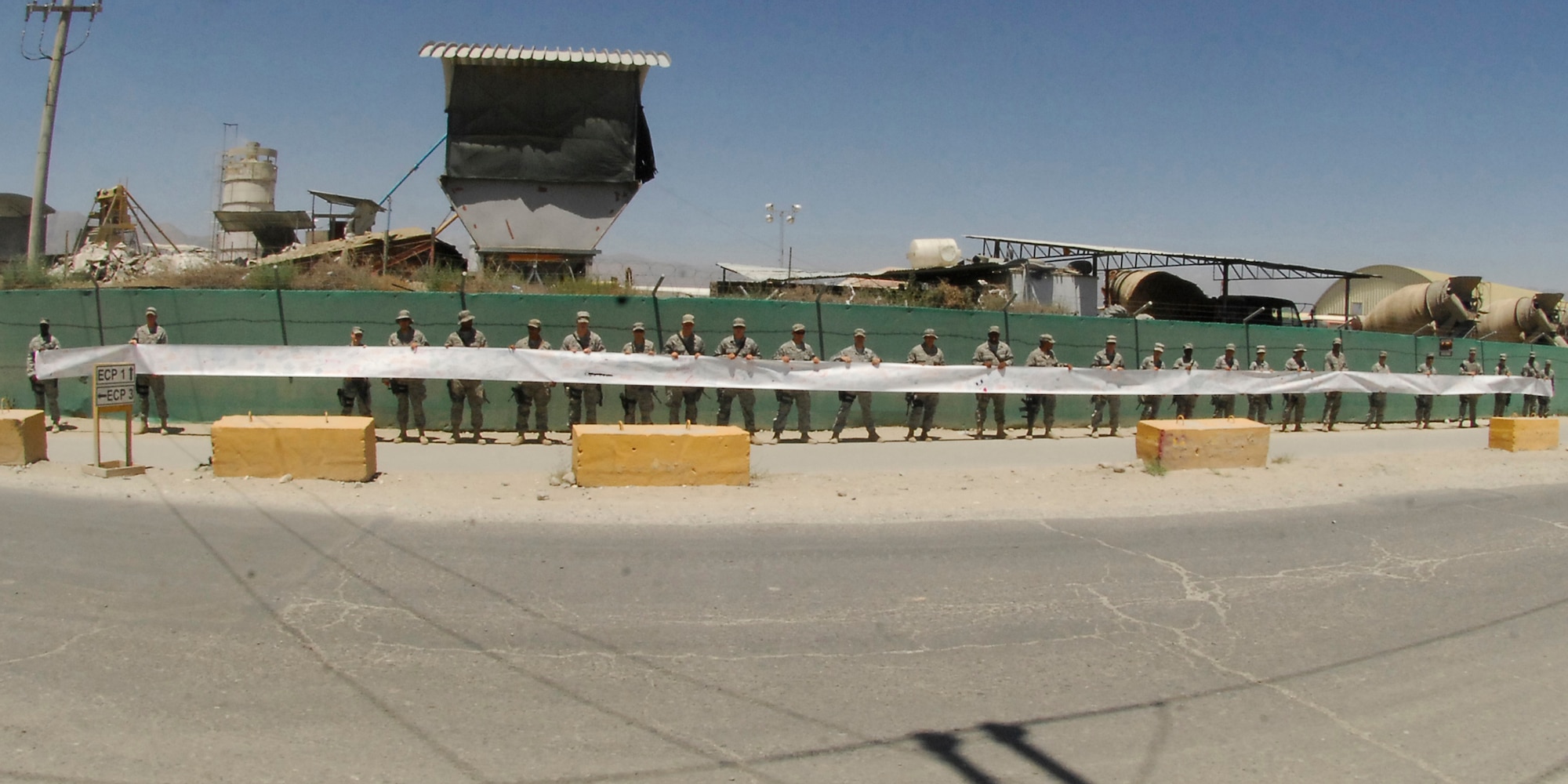 BAGRAM AIRFIELD, Afghanistan - Members of the 455th Expeditionary Security Forces Squadron hang a 480ft. and two inch banner, from Md., to boost morale of the troops, here July 31. (U.S. Air Force photo/Senior Airman Felicia Juenke)