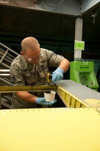 Tech. Sgt. Jack Taylor, 379th Expeditionary Maintenance Squadron aircraft structural maintainer, applies sealer prior to rivoting a KC-135 Stratotanker aileron, July 27, in Southwest Asia. The 379 EMXS fabrication flight has the ability to construct or repair almost any avionic part, keeping the aircraft flying and maintaining mission readiness. Taylor is a native of Fultondale, Ala., and is deployed from Charleston Air Force Base, S.C., in support of Operations Iraqi and Enduring Freedom. (U.S. Air Force Photo/Staff Sgt. Robert Barney)