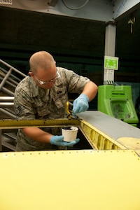Tech. Sgt. Jack Taylor, 379th Expeditionary Maintenance Squadron aircraft structural maintainer, applies sealer prior to rivoting a KC-135 Stratotanker aileron, July 27, in Southwest Asia. The 379 EMXS fabrication flight has the ability to construct or repair almost any avionic part, keeping the aircraft flying and maintaining mission readiness. Taylor is a native of Fultondale, Ala., and is deployed from Charleston Air Force Base, S.C., in support of Operations Iraqi and Enduring Freedom. (U.S. Air Force Photo/Staff Sgt. Robert Barney)