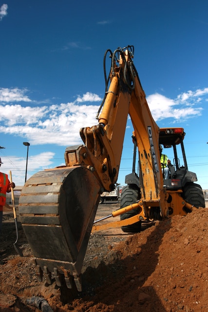 Glenn Redmond, a backhoe operator for Reyes Construction, smooths out ground to build a new parking lot at the Combat Center Aug. 3. The Helmets to Hardhats program is designed to help transitioning service members find careers in the construction industry.
