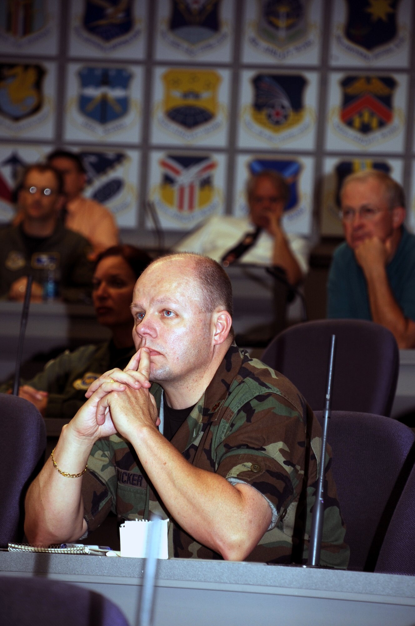 Audience members listen in to the "Tanker Living Legends" speaker series at the Global Reach Planning Center July 30, 2009, at Scott Air Force Base, Ill.  The "Living Legends" speaker series includes a panel of veterans of past conflicts highlighting their experiences in air refueling during those military operations.  This session included Air Mobility Command Vice Commander Lt. Gen. Rusty Findley; retired Maj. Gen. Timothy "T.C." Jones, former Director of Programs at the Office of the Deputy Chief of Staff for Strategic Plans and Programs at Air Force Headquarters; retired Brig. Gen. Thomas Stickford, former 18th Air Force vice commander; and Col. Roger Watkins, commander of the 14th Flying Training Wing at Columbus Air Force Base, Miss. The panel observed their experiences from Operation Allied Force - the Air War over Kosovo in 1999. (U.S. Air Force Photo/Tech. Sgt. Scott T. Sturkol)