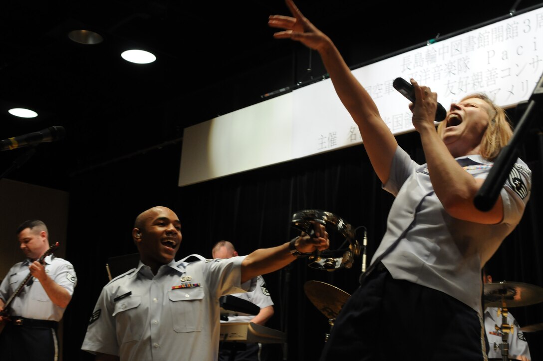 SrA Andrew Jones and TSgt(s) Rebecca Packard belt the final note of "Proud Mary" at a community relations concert in Japan. Photo by TSgt Kimberly Spinner.