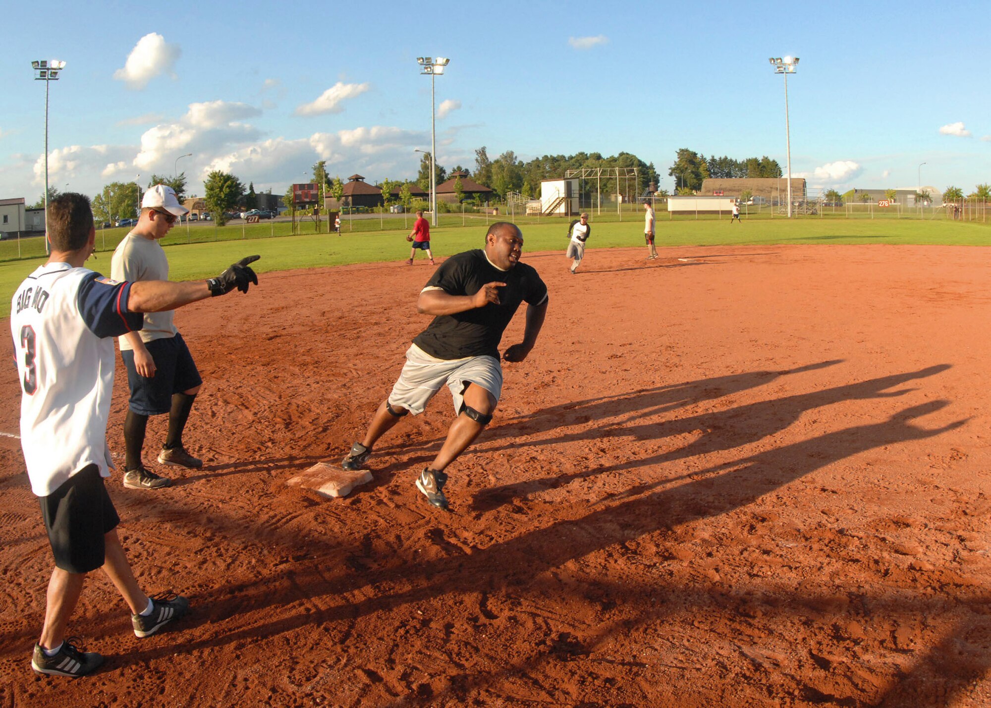 SPANGDAHLEM AIR BASE, Germany -- Moses Palermo, 52nd Security Forces Squadron, tells Terrance Russel, 52 SFS, to run home for here July 30. The Security Forces intramural softball team was defeated by the 52nd Component Maintenance Squadron-A team 14-12 to win the 2009 National League Championship. (U.S. Air Force photo by Airman 1st Class Nick Wilson)