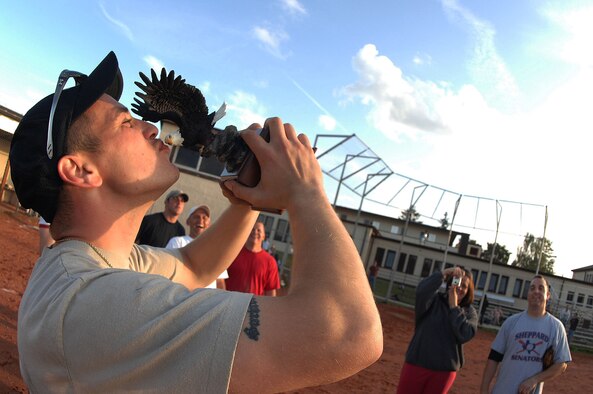 SPANGDAHLEM AIR BASE, Germany -- Robert Marcy, 52nd Component Maintenance Squadron aerospace propulsion technician, kisses his team's trophy after winning the 2009 National League Championship for intramural softball here July 30. The Component Maintenance Squadron-A  team defeated Security Forces 14-12. (U.S. Air Force photo by Airman 1st Class Nick Wilson)