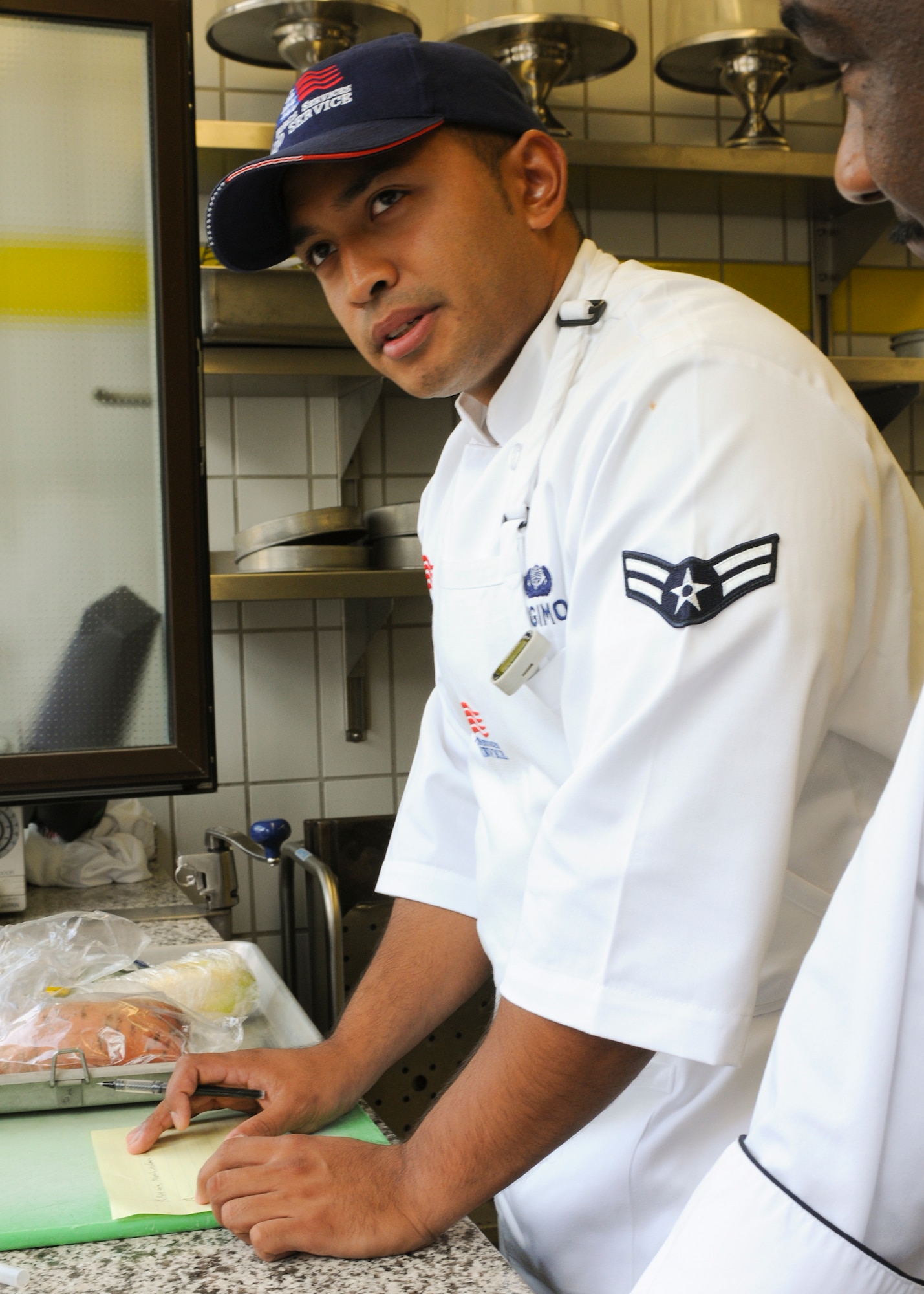 SPANGDAHLEM AIR BASE, Germany -- Airman 1st Class Jason Sugimoto, 52nd Force Support Squadron food service journeyman, plans his menu for the U.S. Air Forces in Europe Iron Chef Competition July 30 at Kapaun Air Station, Germany. Airman Sugimoto was one of seven contestants to compete in the competition. Airman Sugimoto placed runner-up for the competition and was selected to attend the Culinary Institute of America in Napa Valley, California for training along with Iron Chef winner Staff Sgt. Kiana Mobley, 48th Force Support Squadron, Royal Air Force Lakenheath. (U.S. Air Force photo by Airman 1st Class Nathanael Callon)