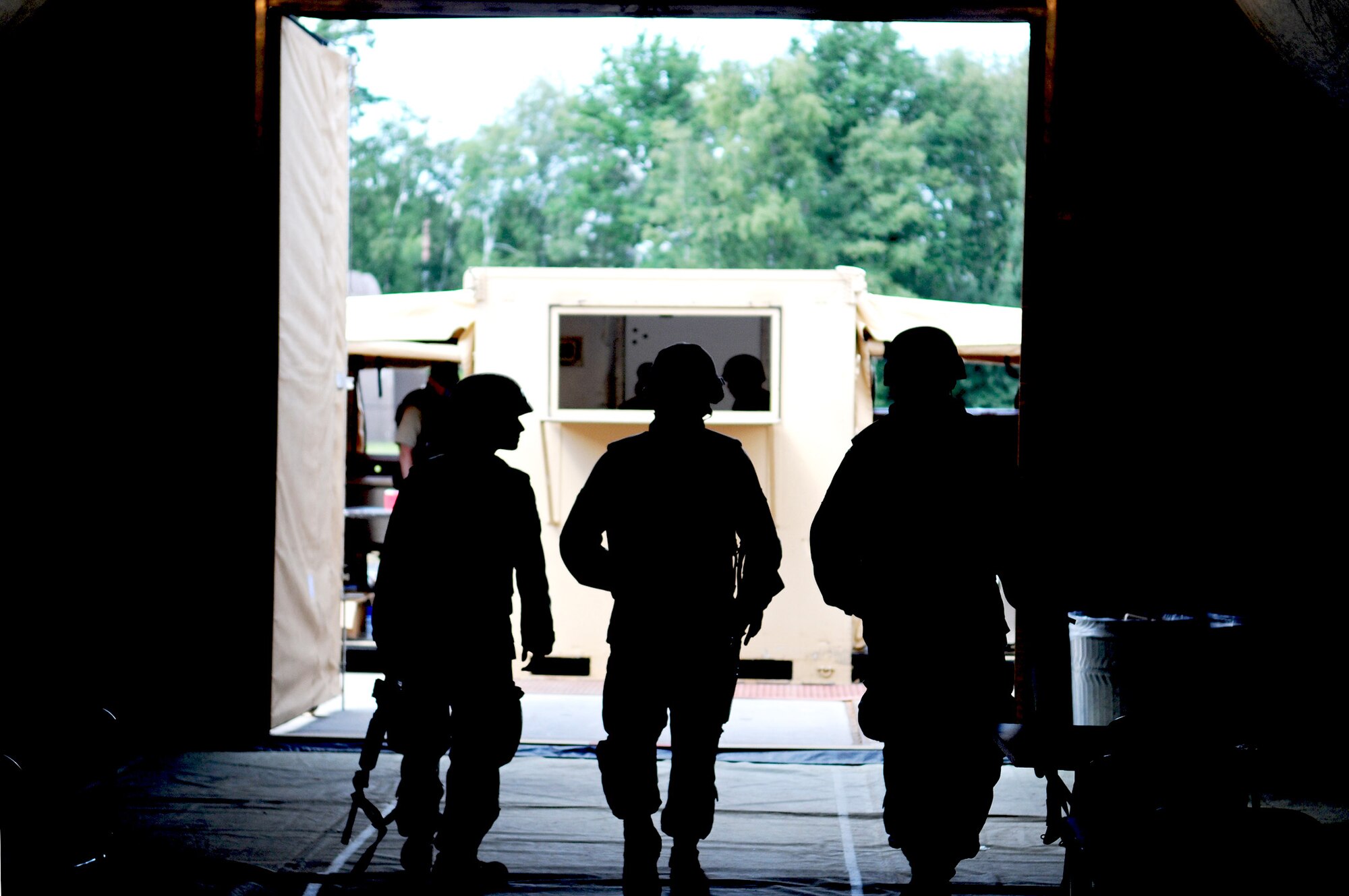 Airmen leave the dining facility tent after eating a meal Aug. 1 during the Silver Flag exercise at Ramstein Air Base, Germany.  Silver Flag gives participants the basic contingency skills to set up a bed-down operation anywhere in the world.  (U.S. Air Force photo/Airman 1st Class Grovert Fuentes-Contreras)