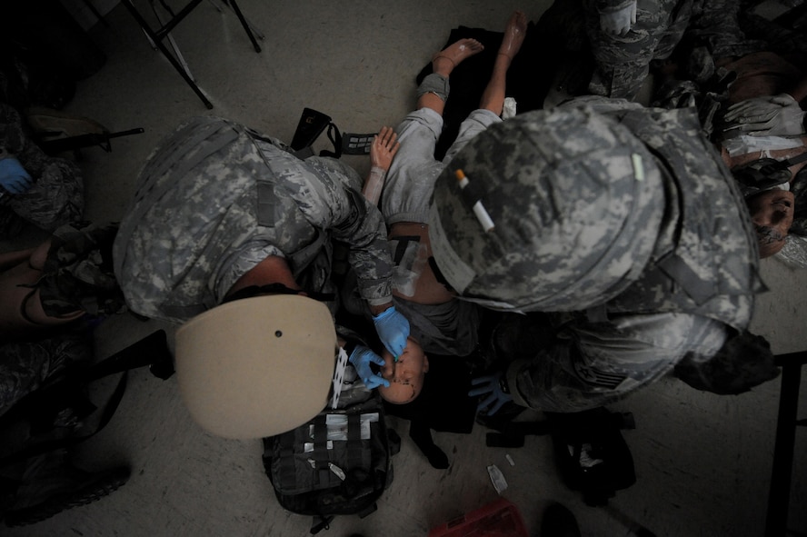 CAMP BLANDING, Fla. -- Airmen from the 93rd Air Ground Operations Wing, a tenant wing at Moody Air Force Base, Ga., along with other combat weather Airmen assigned at various installation, perform medical care on a simulated victim during a  combat lifesaver skills course here July 17. During the training, Airmen from non-medical Air Force Specialty Codes are taught advanced first-aid and lifesaving procedures. (U.S. Air Force photo by Senior Airman Gina Chiaverotti-Paige)