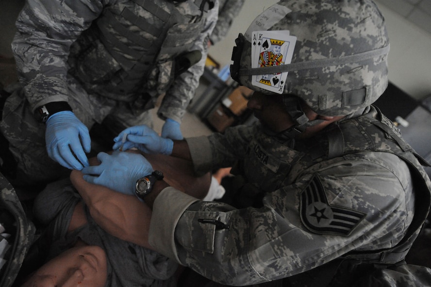 CAMP BLANDING, Fla. -- Staff Sgt. Javier Acosta, a battlefield weather forecaster from Det. 2, 7th Weather Squadron at Grafenwoehr, Germany, performs medical care on a simulated victim during a combat lifesaver skills course here July 17. Members from the 93rd Air Ground Operations Wing, a tenant wing at Moody Air Force Base, Ga., also attended the advanced first-aid and lifesaving procedures course. (U.S. Air Force photo by Senior Airman Gina Chiaverotti-Paige)