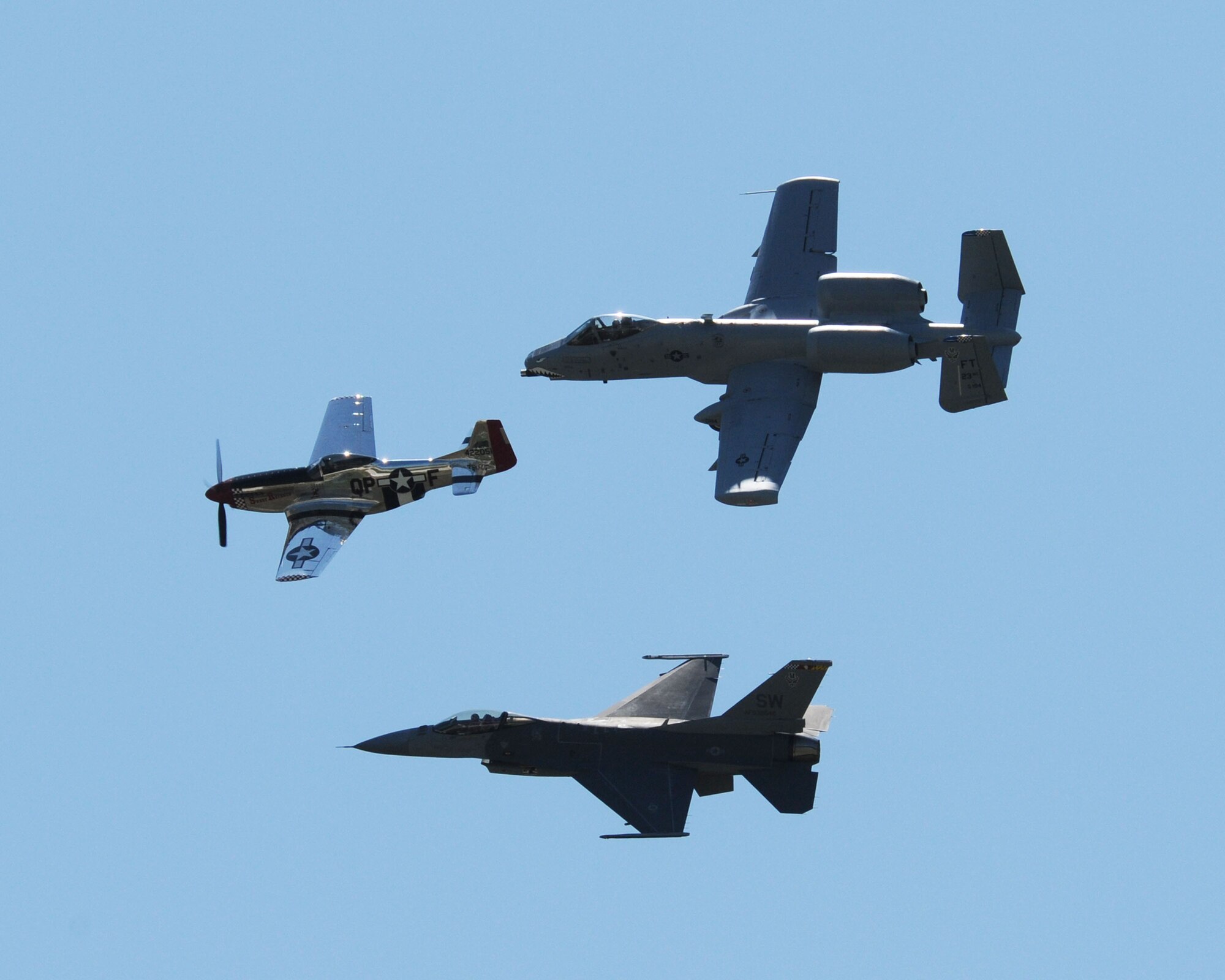 A rare combination of fighter planes teamed up to fly in formation at the Sioux Gateway Airport / Col. Bud Day Field, in Sioux City, Iowa. A World War II era P-51 Mustang took the lead with an  A-10 Thunderbolt II and a F-16 Falcon covering the sides for flying demonstration at the "Air and Ag Show" hosted by the 185th Air Refueling Wing.  Official Air Force Photo by: MSgt. Bill Wiseman (released)