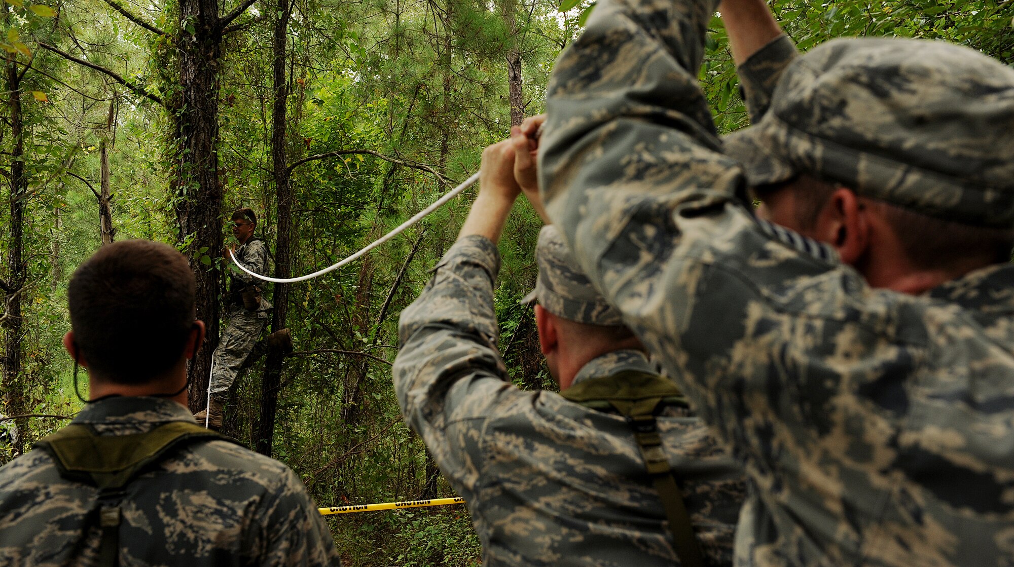 MOODY AIR FORCE BASE, Ga. -- Candidates from the air liaison officer selection course, tie a rope between two trees in order to cross a body of water, during a training scenario held at the 820th Security Forces Group compound here July 24. (U.S. Air Force photo by Airman 1st Class Joshua Green)