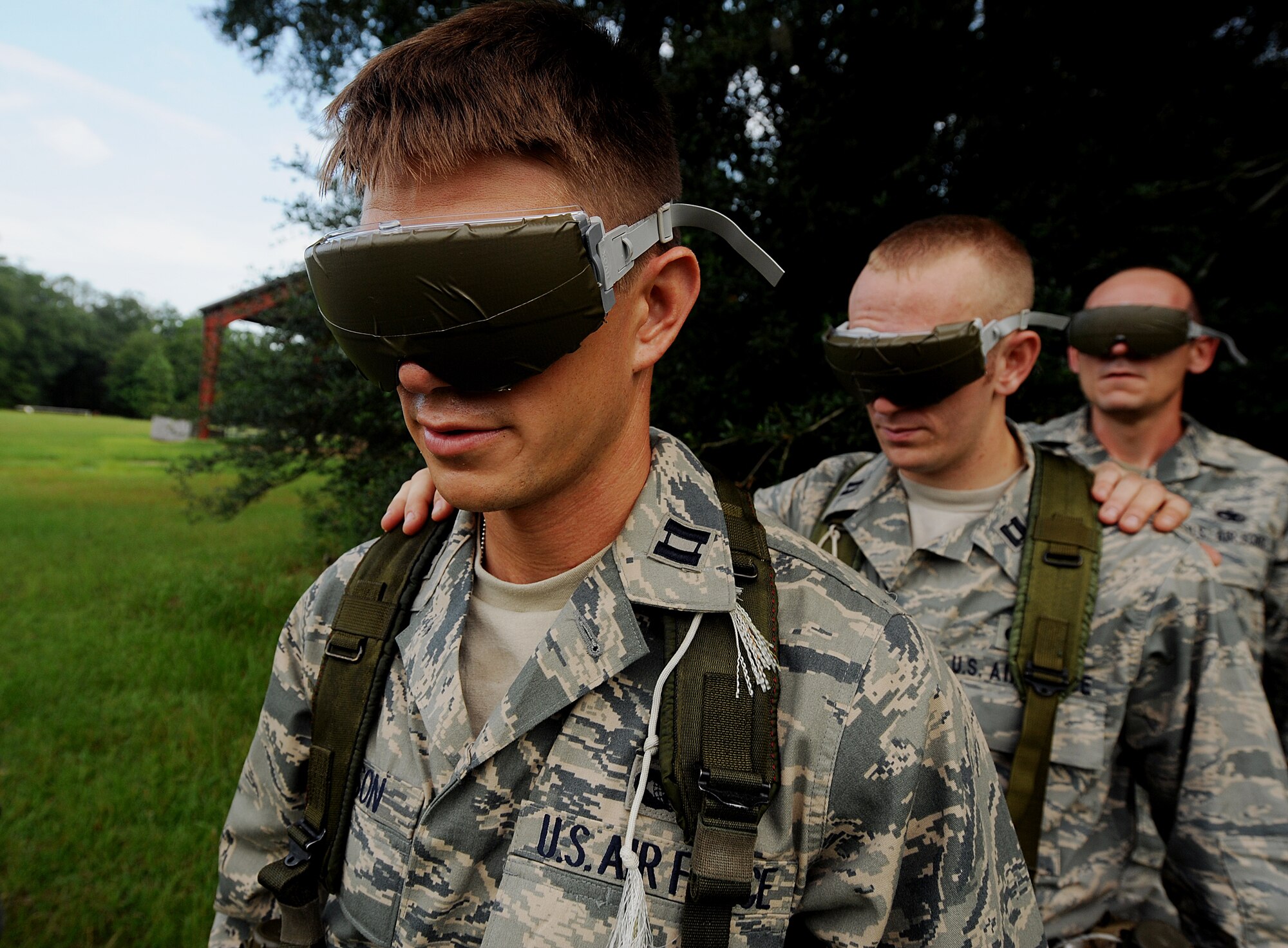 MOODY AIR FORCE BASE, Ga. -- Capt. Matthew Robinson, Capt. Matthew Kealy and Tech. Sgt. Christopher Adams, all candidates from the air liaison officer selection course, wear taped goggles during a leadership reaction training exercise held at the 820th Security Forces Group military operations in urban terrain village here July 24. One candidate was tasked to lead three other candidates with tapped goggles through a simulated mine field. (U.S. Air Force photo by Airman 1st Class Joshua Green)