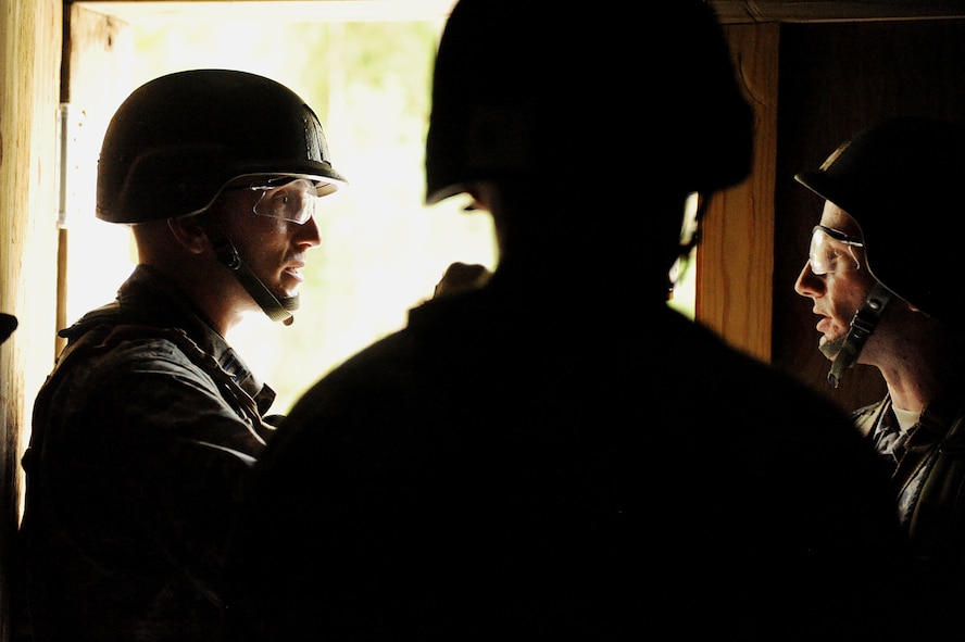 MOODY AIR FORCE BASE, Ga. -- Capt. Matthew Kealy and 2nd Lt. Eamonn Oshea, both candidates from the air liaison officer selection course, discuss a plan of action during a training assignment held at the 820th Security Forces Group military operations in urban terrain village here July 23. The candidates performed scenarios that included clearing the buildings in the village as well as apprehending hostile enemies. (U.S. Air Force photo by Airman 1st Class Joshua Green) 