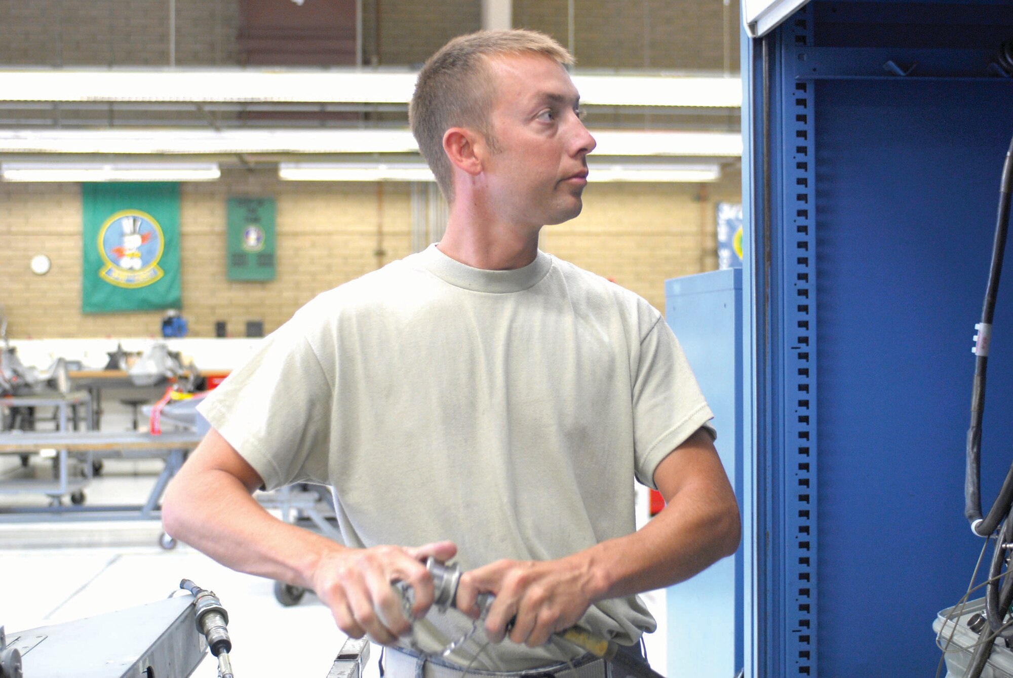 Staff Sgt. Robert Pemberton, 56 Equipment Maintenance Squadron aircraft weapons specialist, connects a wing weapons pylon to an 856 tester during an operational bench check at Luke AFB. (U.S. AIr Force photo by Senior Airman Tracie Forte)