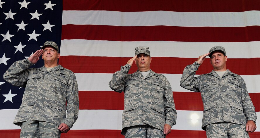 MOODY AIR FORCE BASE, Ga. -- Lt. Gen. Gary North, 9th Air Force and U.S. Air Forces Central commander, Shaw Air Force Base, S.C, Brig. Gen. Michael Longoria, outgoing 93rd Air Ground Operations Wing commander, and Col. John Horner, incoming 93rd AGOW commander, render a salute during the playing of the National Anthem during a change of command ceremony here July 31. (U.S. Air Force photo by Airman 1st Class Joshua Green)