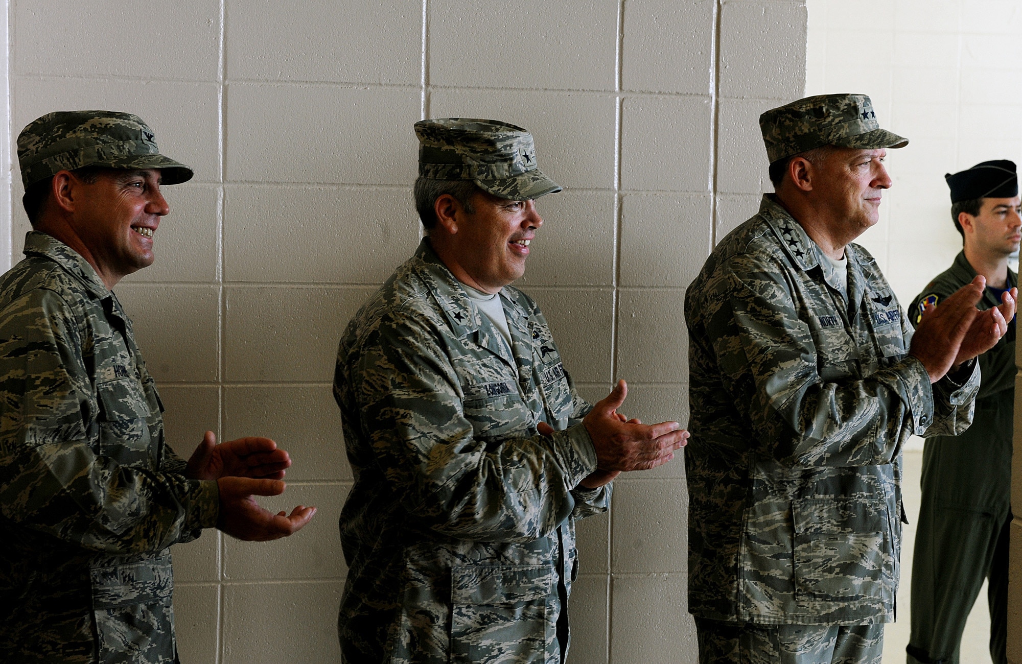 MOODY AIR FORCE BASE, Ga. -- Col. John Horner, incoming 93rd Air Ground Operations Wing commander, Brig. Gen. Michael Longoria, outgoing 93rd AGOW commander, and Lt. Gen. Gary North, 9th Air Force and U.S. Air Forces Central commander, Shaw Air Force Base, S.C, applaud during the start of a change of command ceremony here July 31. General Longoria relinquished command of the 93rd AGOW to Colonel Horner. (U.S. Air Force photo by Airman 1st Class Joshua Green)