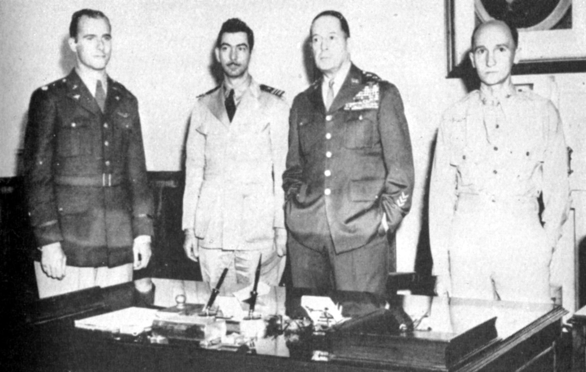 Lt. Col. William E. Dyess (left) reporting to Gen. MacArthur (second from right). Also pictured are two of his fellow escapees, Lt. Cmdr. M.H. McCoy (second from left) and Maj. S.M. Mellnik. (U.S. Air Force photo)