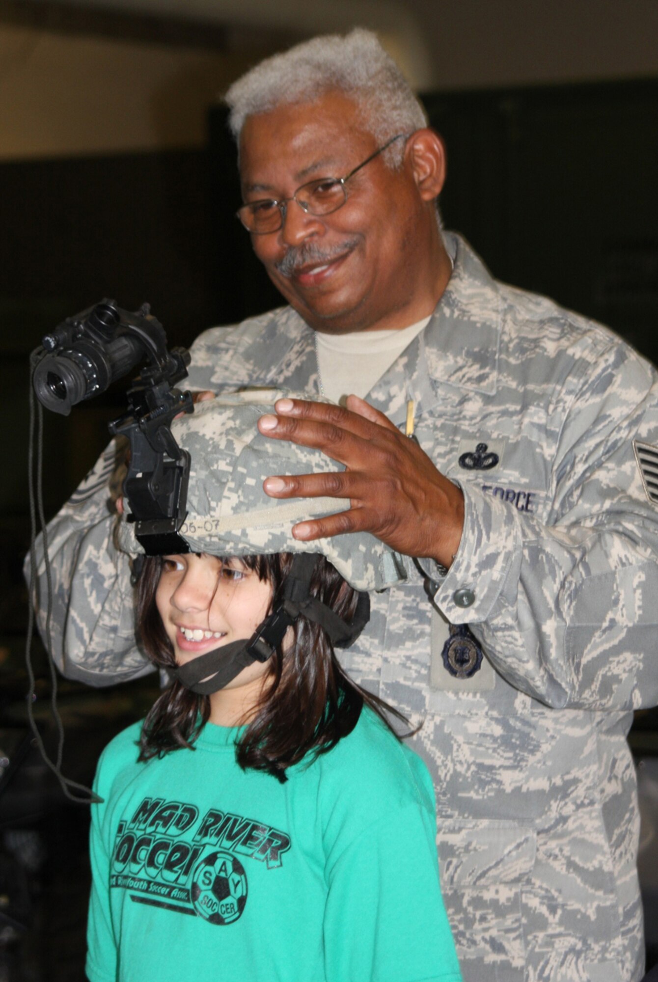 Tech. Sgt. Michael Pennington of the 445th Security Forces Squadron, Wright-Patterson Air Force Base, Ohio, explains how night-vision goggles work July 21, 2009.Sergeant Pennington and other reservists demonstrated their skills to military children participating in Operation Purple Camp July 13-14 and July 20-21. (U. S. Air Force photo/Staff Sgt. Amanda Duncan)
