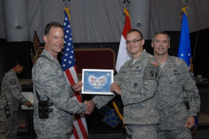 Senior Airman Gemenie Strehlow recieves a certificate of appreciation during a ceremony while deployed to Iraq.  Strehlow is a member of the 119th Wing Security Forces Squadron based in Fargo, N.D.