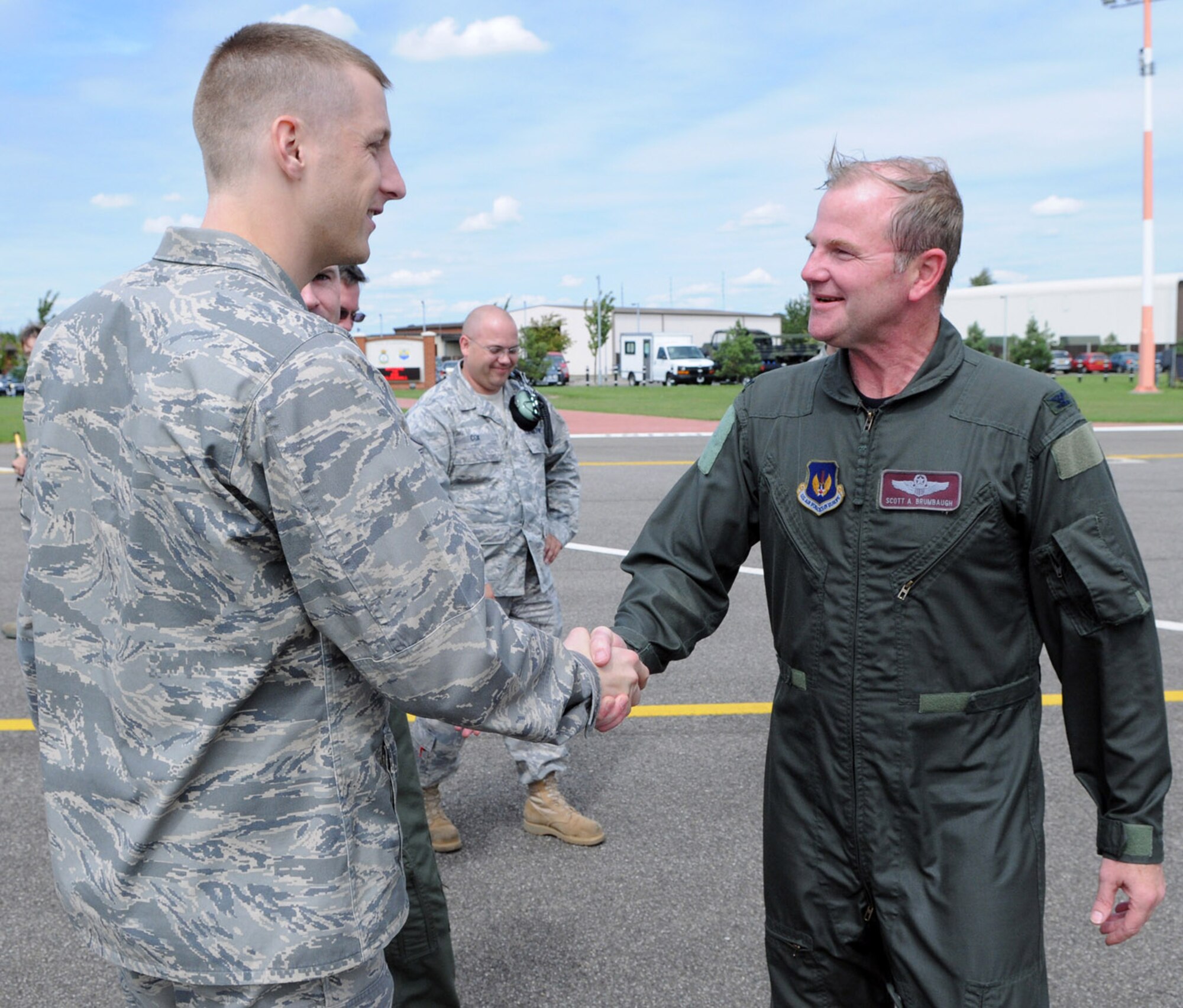 RAF MILDENHALL, England -- Col. Scott Brumbaugh, 100th Air Refueling Wing vice commander, individually thanks those who came out to his "fini flight" celebration.  Colonel Brumbaugh flew his final mission in a 100th ARW KC-135 July 31. (U.S Air Force photo by Staff Sgt. Austin M. May)

