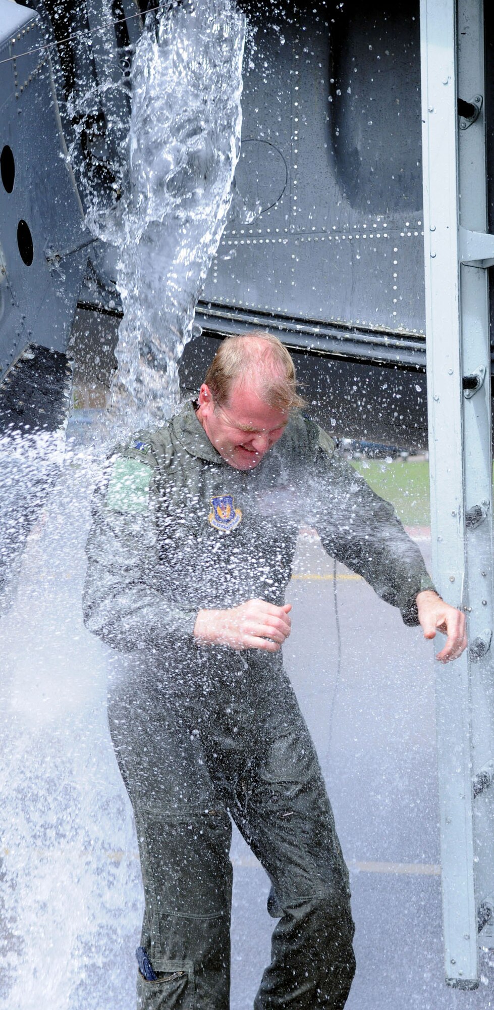 RAF MILDENHALL, England -- Water from all directions soaks Col. Scott Brumbaugh, 100th Air Refueling Wing vice commander, as part of his "fini flight," a celebration of his final flight for his current assignment.  Colonel Brumbaugh has been the vice commander of the 100th Air Refueling Wing since May 2007.(U.S Air Force photo by Staff Sgt. Austin M. May)