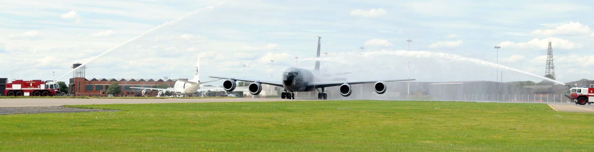RAF MILDENHALL, England -- A KC-135 Stratotanker piloted by Col. Scott Brumbaugh, 100th Air Refueling Wing vice commander, taxis beneath the spray of a pair of RAF Mildenhall's fire trucks July 31.  The spectacle was part of the colonel's "fini flight," a celebration of his final flight for his current assignment.  (U.S Air Force photo by Staff Sgt. Austin M. May)