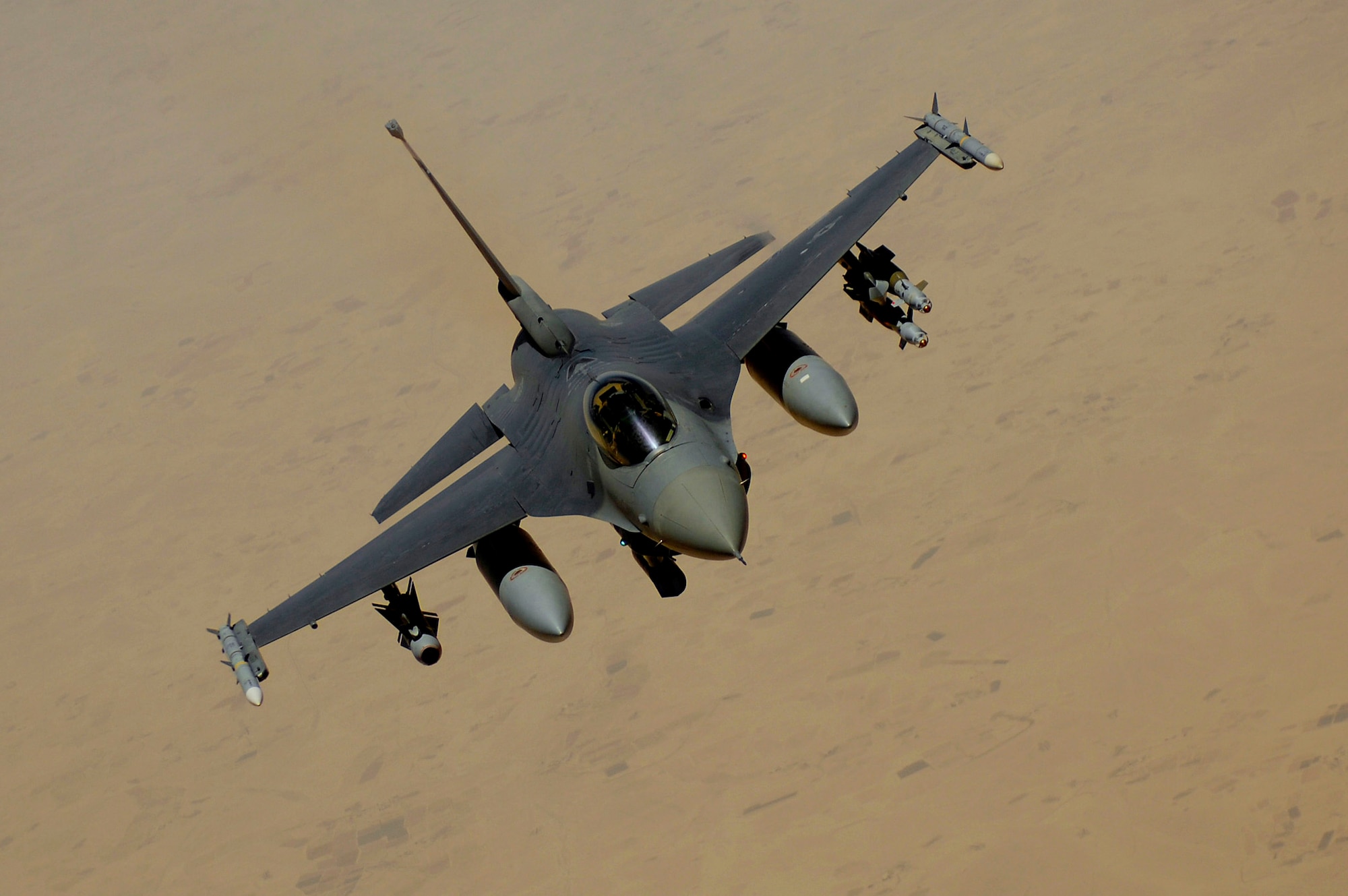 An F-16 Fighting Falcon flies over Southwest Asia. The F-16 is highly maneuverable and has proven itself in air-to-air combat and air-to-surface attack.  (U.S. Air Force photo/Master Sgt. Andy Dunaway)
