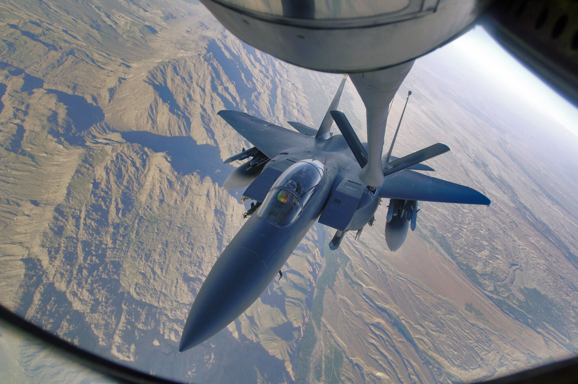 An F-15E Strike Eagle refuels over the mountains of Afghanistan. The F-15E provides close-air support and armed aerial overwatch to deter enemy activities. (U.S. Air Force photo)
