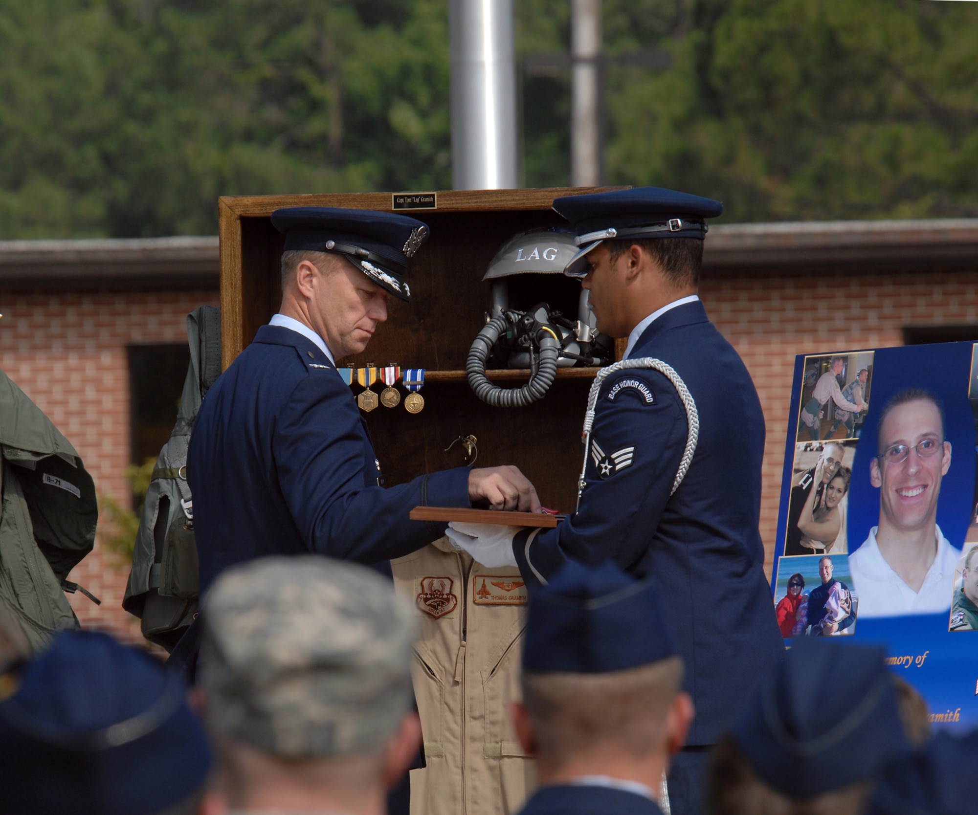 Colonel Mark Kelly,4th Fighter Wing commander, awards the Bronze Star posthumously to Capt. Thomas Gramith. Captain Gramith was the weapons systems officer killed in an F-15E Strike Eagle crash in eastern Afghanistan July 18.(U.S. Air Force photo by Master Sgt. Brandt Smith)