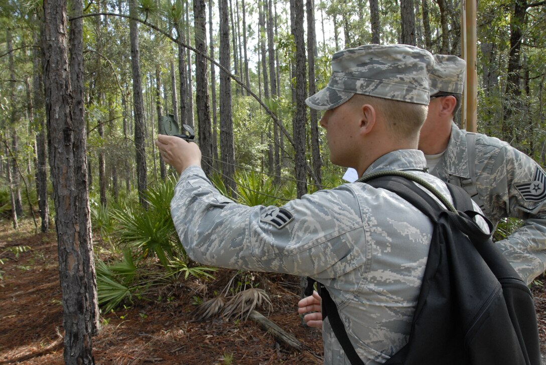 Senior Amn. Nick Hoots and Technical Sgt. John Lewis, both from the 3rd Weather Squadron, Fort Hood Texas, use land navigation skills to find a checkpoint at Camp Blanding Joint Training Center, Fla. The land navigation is part of exercise Cyclogenesis, and training exercise designed to prepare combat weather Airmen for deployment with the Army. (Air National Guard photo by TSgt. Jeffrey Trumble)