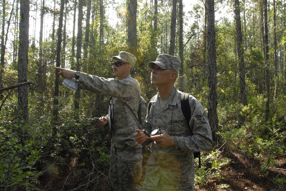 Senior Amn. Nick Hoots and Technical Sgt. John Lewis, both from the 3rd Weather Squadron, Fort Hood Texas, use land navigation skills to find a checkpoint at Camp Blanding Joint Training Center, Fla. The land navigation is part of exercise Cyclogenesis, and training exercise designed to prepare combat weather Airmen for deployment with the Army. (Air National Guard photo by TSgt. Jeffrey Trumble)