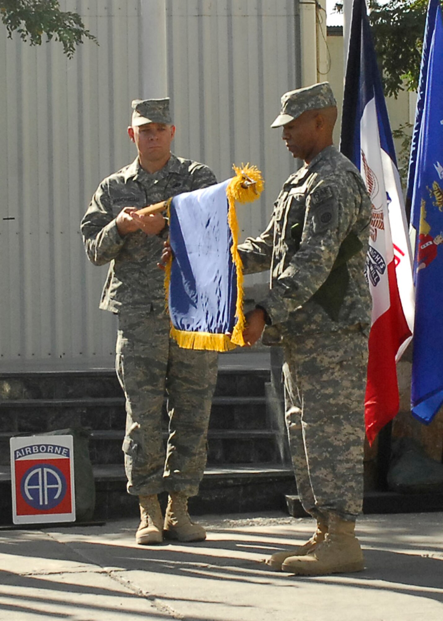 BAGRAM AIRFIELD, Afghanistan - Chief Master Sgt. Dennis Vannorsdall, 455th Expeditionary Wing command chief, unfurls the general officer flag of Brig. Gen. Steven L. Kwast, 455th AEW commander, with the assistance of Command Sgt. Maj. Thomas Capel, CJTF-82, command sergeant major. A general officer flag is a time-honored tradition in the military service. (U.S. Air Force photo/Senior Airman Felicia Juenke)