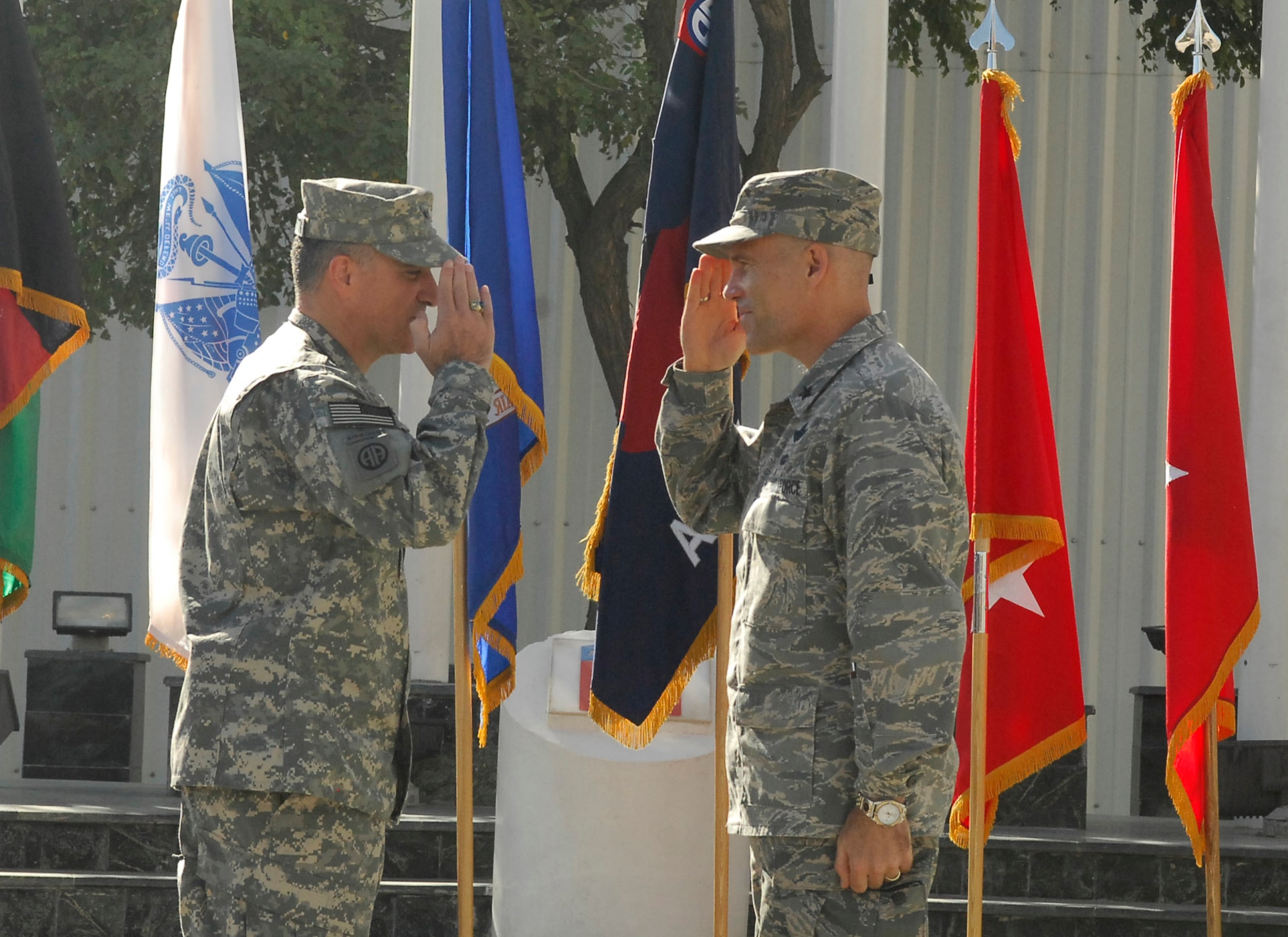 BAGRAM AIRFIELD, Afghanistan - Army Major General Curtis M. Scaparrotti, CJTF-82 commander, salutes Brig. Gen. Steven L. Kwast, 455th Air Expeditionary Wing commander after pinning on his new rank. (U.S. Air Force photo/Senior Airman Felicia Juenke)