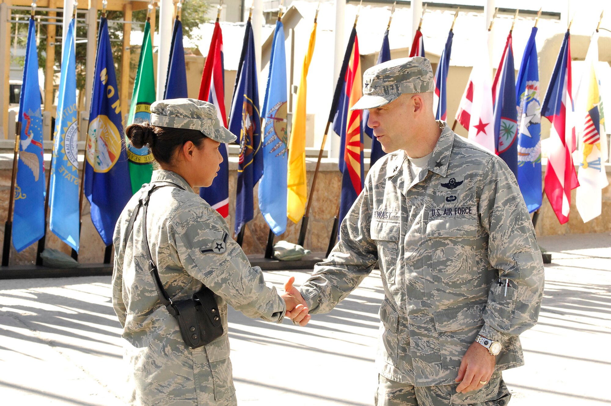 BAGRAM AIRFIELD, Afghanistan - Airman Myka San Nichols, 455th Expeditionary Security Forces Squadron, receives a personal coin from Brig. Gen. Steven L. Kwast. Airman San Nichols is the youngest Airman at BAF and served as the proffer in the general's ceremony. Airman San Nichols is deployed from Tinker Air Force Base, Okla., and hails from Agana, Guam. (U.S. Air Force photo/Senior Airman Felicia Juenke)