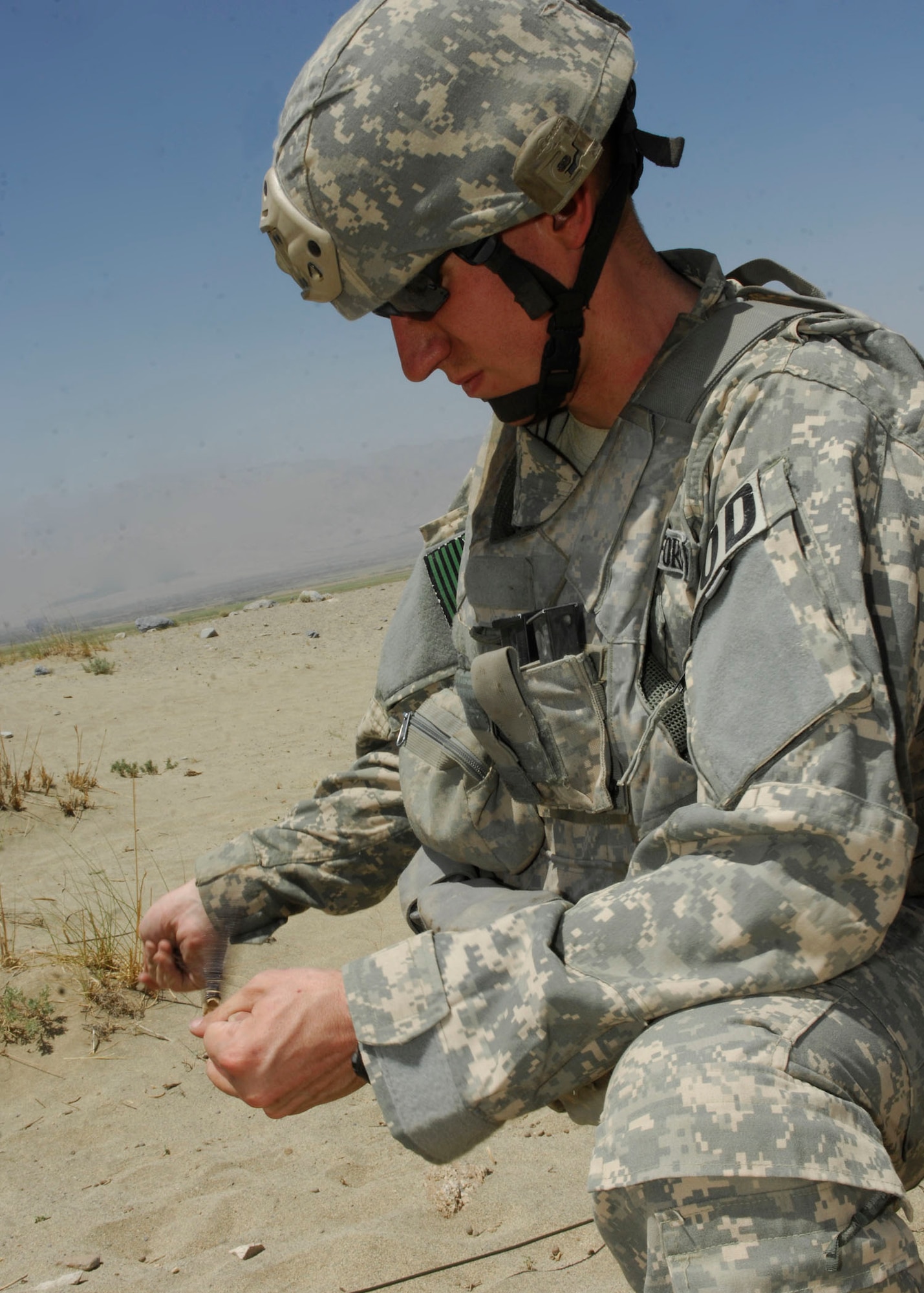 BAGRAM AIRFIELD, Afghanistan - Staff Sgt. Greg Talley, 755th Air Expeditionary Group, Explosive Ordnance Disposal technician, prepares to hook up electronic blasting caps to a control box that he will use to destroy a cache of weapons, including discarded Soviet munitions from the 1970s, at an ordnance disposal site near BAF. Sergeant Talley is deployed from Dyess Air Force Base, Texas and hails from Rogers, Ark. (U.S. Air Force photo/Tech. Sgt. John Jung)