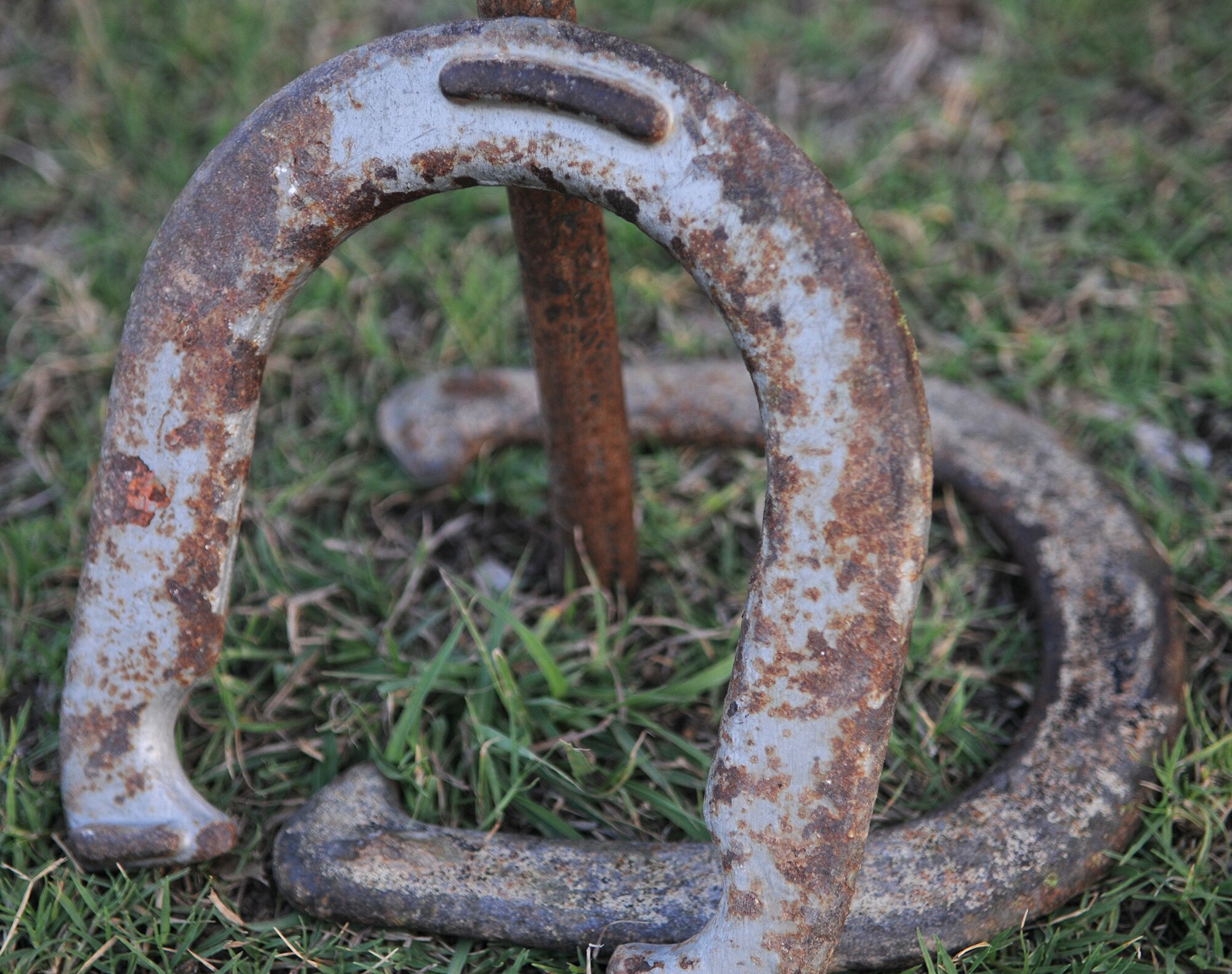 Horseshoes rest on and near a stake during a horseshoe tournament Thursday, July 30, 2009 at the consolidated club, Incirlik Air Base, Turkey. Eight people participated in the tourney that was hosted by the club. Charlotte Kinser, 39th Force Support Squadron civilian personnel, won the first-place prize of $150. (U.S. Air Force photo/Senior Airman Alex Martinez)