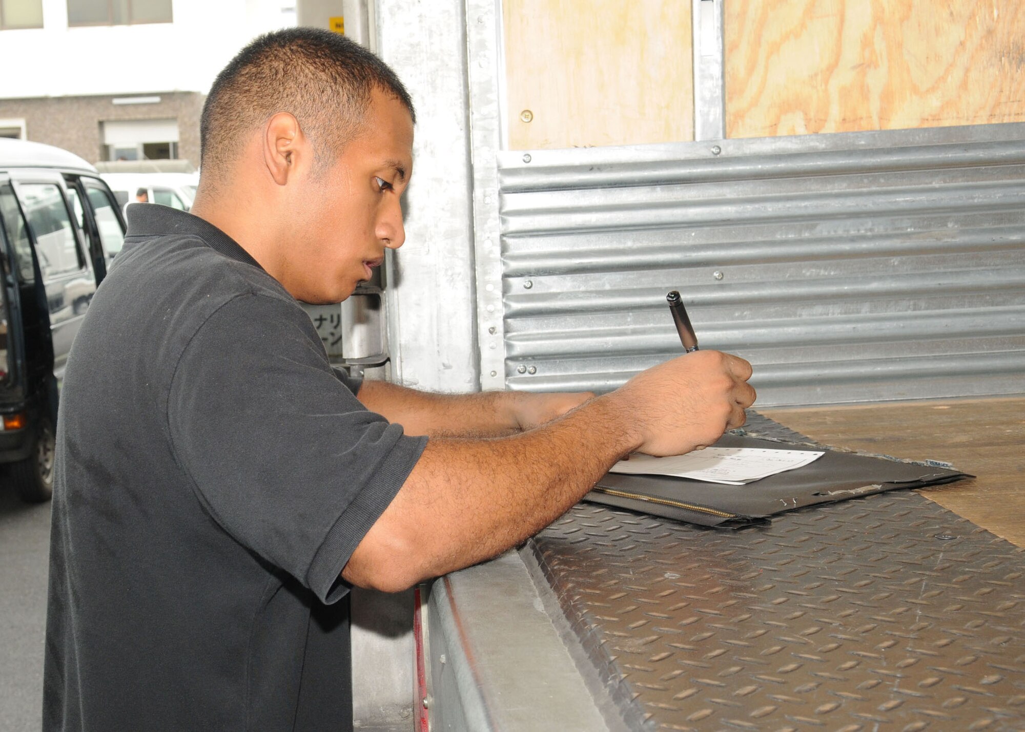 NARITA, Japan -- Senior Airman Jeremy Toribio-Sullon, Det. 2 Pacific Air Forces Air Postal Squadron mail control agent, fills out Fleet Mail Center dispatch paperwork for mail destined for U.S. Navy personnel July 31 at Narita International Airport. The squadron of 11 military and seven Japanese members handles nearly 30 million pounds of mail each year for all of mainland Japan. Mail flown in from all over the world is trucked to various installations throughout the Kanto Plain. (U.S. Air Force photo/Airman 1st Class Sean Martin)