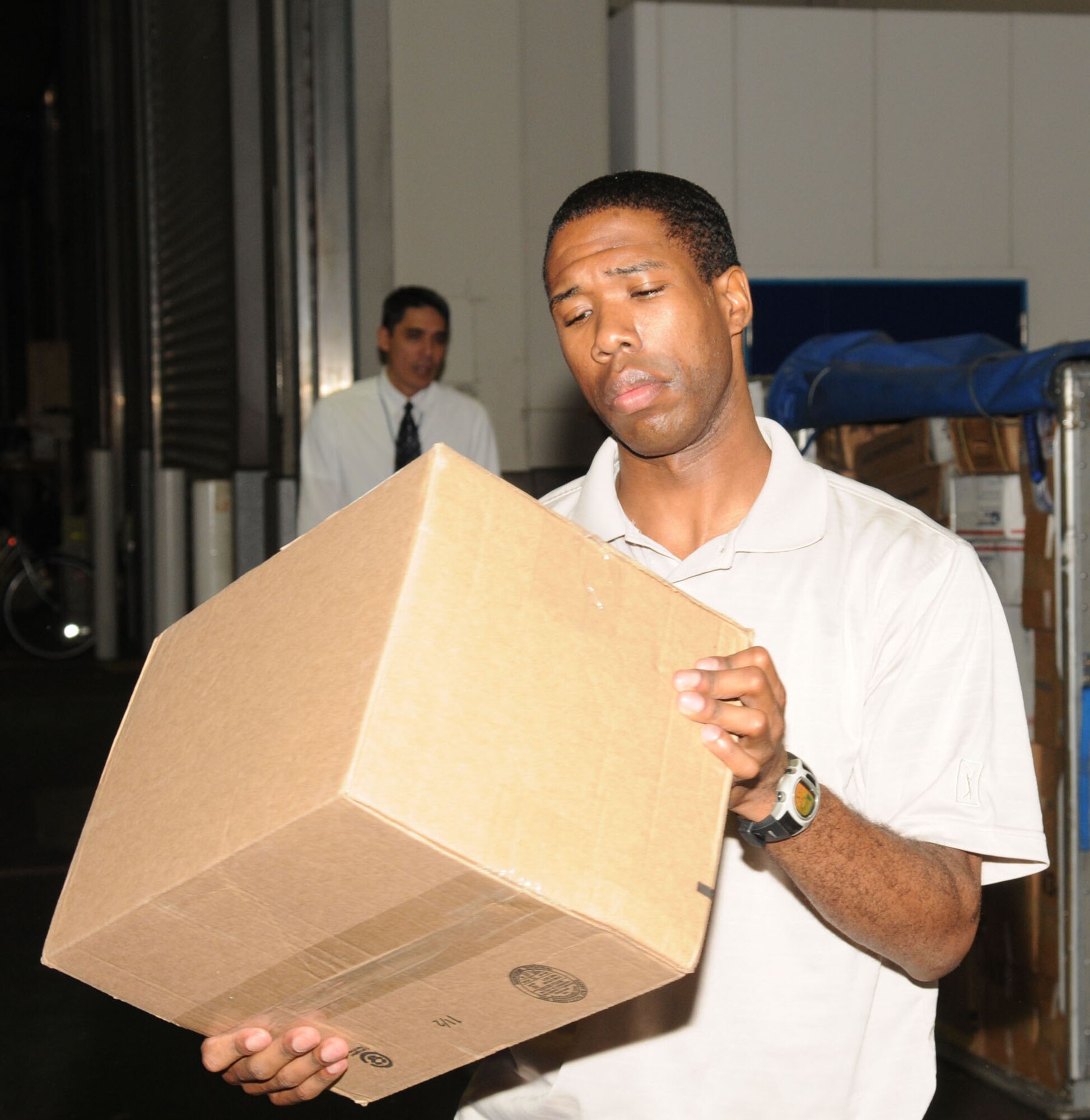 NARITA, Japan -- Staff Sgt. Mario Manago, Det. 2 Pacific Air Forces Air Postal Squadron mail control agent, verifies the destination on a piece of mail July 31 at Narita International Airport. The squadron of 11 military and seven Japanese members handles nearly 30 million pounds of mail each year for all of mainland Japan. Mail flown in from all over the world is trucked to various installations throughout the Kanto Plain. (U.S. Air Force photo/Airman 1st Class Sean Martin)