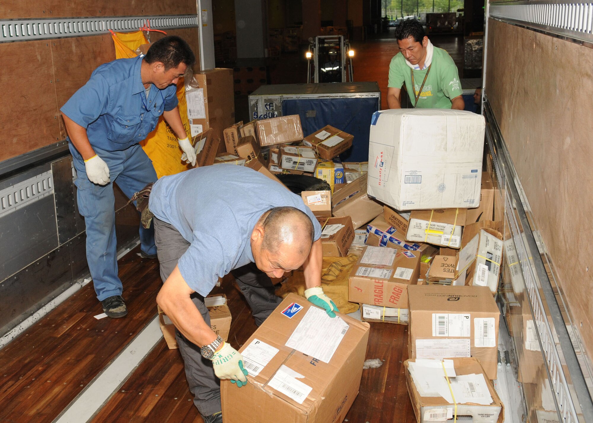 NARITA, Japan -- Mail control agents load mail onto a transport truck July 31 at Narita International Airport. The squadron of 11 military and seven Japanese members handles nearly 30 million pounds of mail each year for all of mainland Japan. Mail flown in from all over the world is trucked to various installations throughout the Kanto Plain. (U.S. Air Force photo/Airman 1st Class Sean Martin)