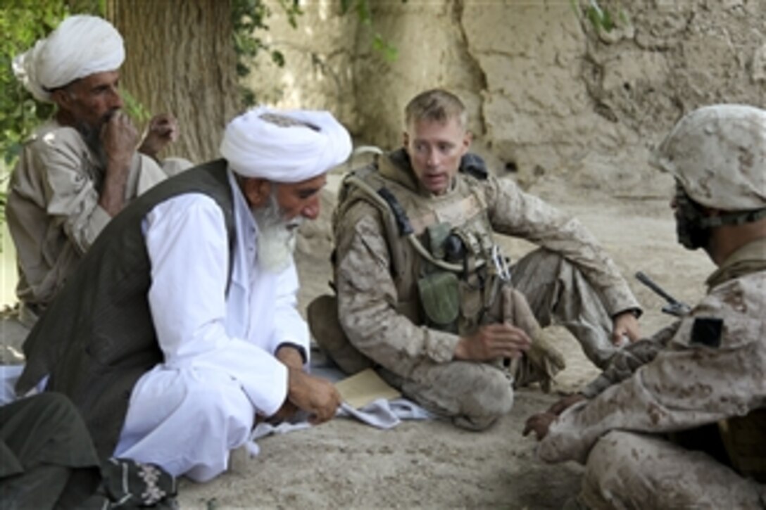 Hamadulha Helmand, a leader in the Barackside tribe, speaks with U.S. Marine Corps Lt. Col. William McCollough, the commander of 1st Battalion, 5th Marine Regiment, about district infrastructure improvements during a civil affairs group patrol in the Nawa District of Helmand province, Afghanistan, on July 30, 2009.  