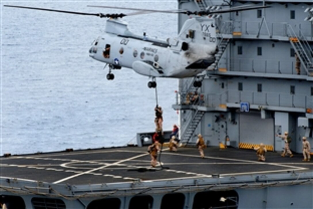 U.S. Marines fast rope out of an Ch-46E Sea Knight on to the deck of the replenishment oiler USNS Yukon during a visit, board, search and seizure exercise in the Pacific Ocean, July 30, 2009. The Marines are embarked aboard the amphibious dock landing ship USS Rushmore, which is conducting a composite training exercise to prepare for a scheduled deployment to the western Pacific Ocean later this year.