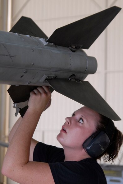 KUNSAN AIR BASE, Republic of Korea -- Staff Sgt. Jennifer Campbell, a weapons loader assigned to the 35th Aircraft Maintenance Unit, installs a fin to the AIM-120 missile during a weapons loading competition here July 31. Her team competes against the 80th Aircraft Maintenance Unit in a monthly weapons loading competition to determine which team will represent the 8th Fighter Wing. Sergeant Campbell is a native of Wheatland, Calif. (U.S. Air Force photo/Staff Sgt. Darnell T. Cannady)