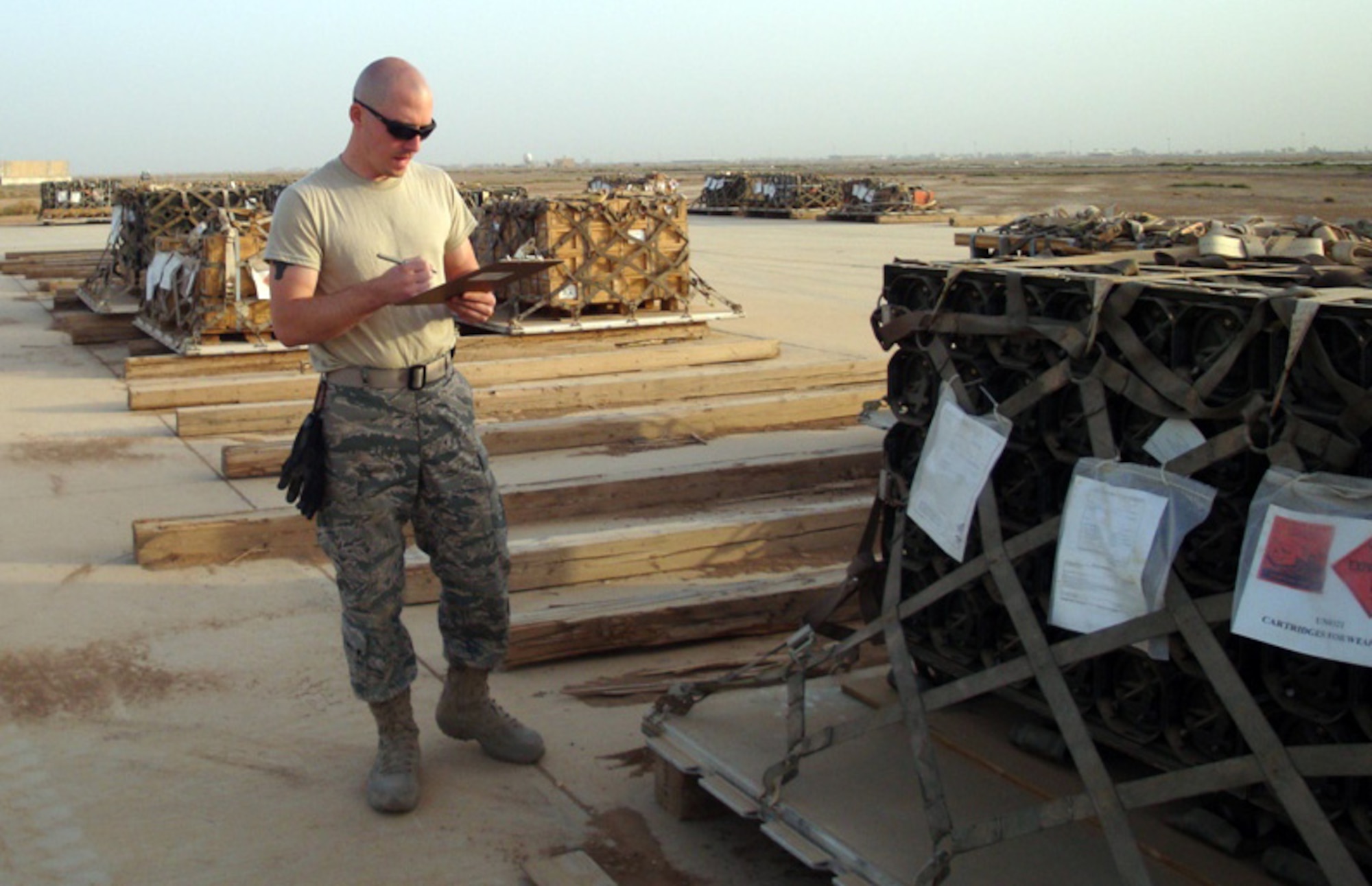 Tech. Sgt. Josh Warbiany, a Reservists with the 86th Aerial Port Squadron, McChord Air Force Base, Wash., performs a check on explosives cargo at Balad Air Base, Iraq. Sergeant Warbiany was deployed with fellow aerial porters from the McChord 36th and 86th Aerial Port Squadrons, December 2008 to May 2009. (U.S. Air Force photo/Master Sgt. Denise White)