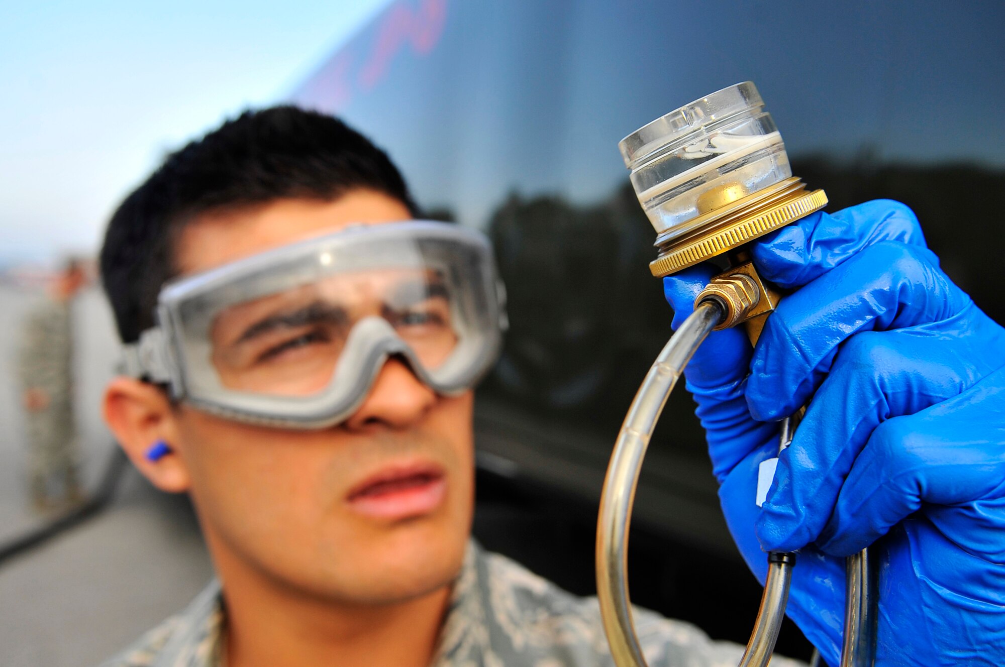 Airman 1st Class Andrew Leal inspects jet fuel in an inline sampler taken from a fuel truck during Red Flag-Alaska 09-3 July 31, 2009, Eielson AFB. During the two week exercise, approximately 2.6 million gallons of fuel will be used for the participating aircraft. Airman Leal is assigned to the 354th Logistics Readiness Squadron, fuels management flight. (U.S. Air Force photo/Staff Sgt. Christopher Boitz)
