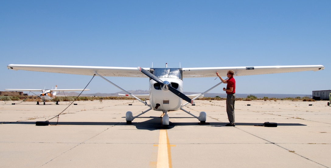 Tim Taylor, Edwards Aero Club full-time flight instructor, checks one of the wings of a Cessna aircraft. The club provides many stages of flight training, from introductory flight to solo, then on to private, commercial and instructors' ratings. (U.S. Air Force photo/Senior Airman Julius Delos Reyes)