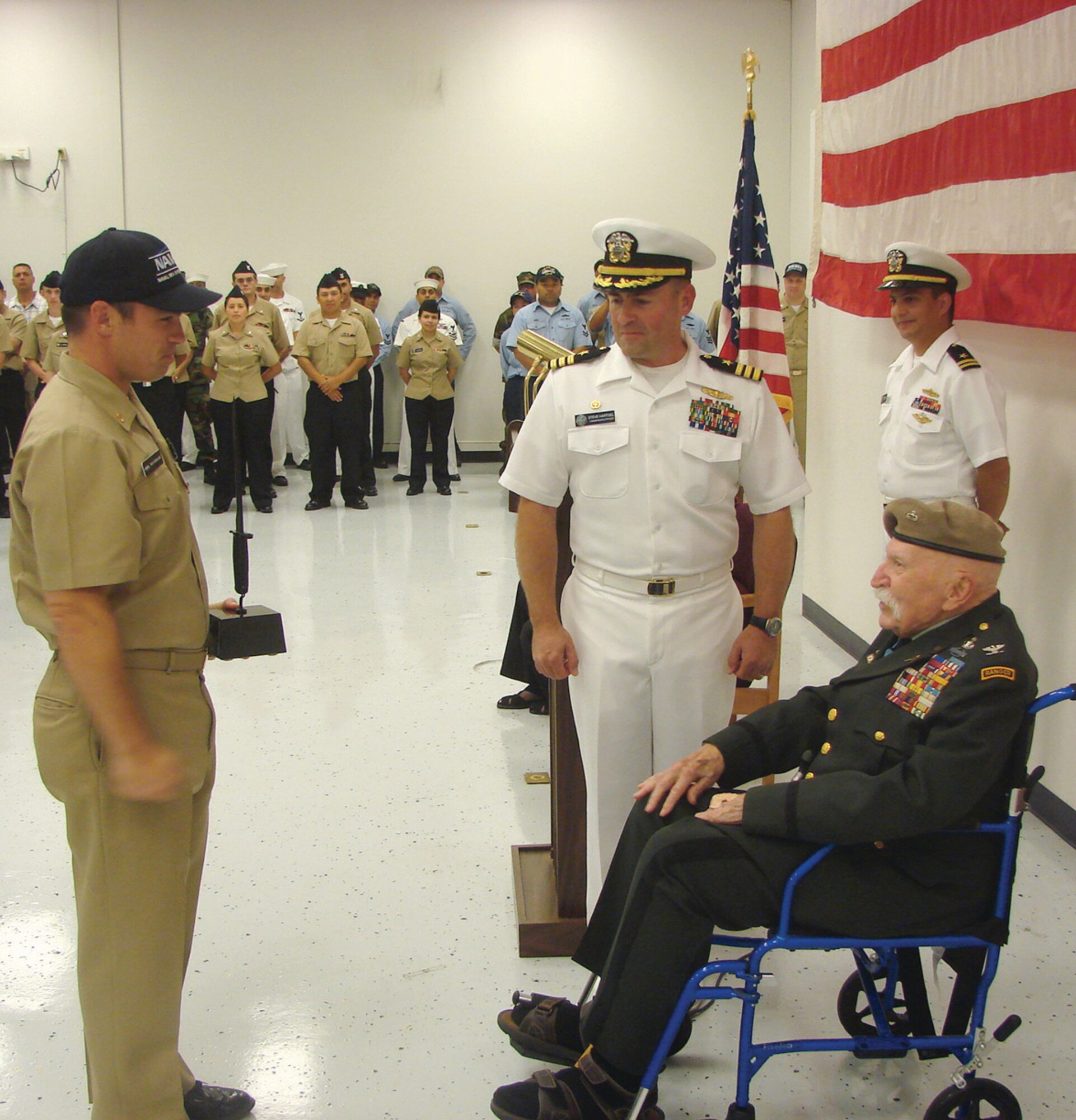 Lt. Cmdr. Richard Ardolino, Commanding Officer of Navy Surgemain Unit 224, receives the first annual Colonel Millett Unit Excellence Award presented by the award’s namesake, Medal of Honor recipient Col. Lewis Millett, on July 18. During the Korean War, Col. Millett led America’s heaviest bayonet charge since the Civil War. (U.S. Navy photo by Fire Controlman 1st Class Carlos Cruz)